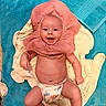 Amiyah is registered to the contest to win money with this photo: baby, infant, diaper, towel, pink_bonnet, smiling, happy, skin, bare_chest, lying_down, floor, footwear, blue_towel, cream_towel, cute, child, playful, indoors, expression, portrait