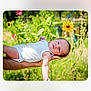 baby, infant, white_onesie, arm, hand, flower, sunflower, greenery, outdoor, nature, garden, daylight, peaceful, person, skin, portrait, summer, flora, resting, young_child
