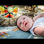 Blake joined the competition — help win amazing prizes! baby, infant, face, smiling, lying_down, blanket, pattern, feathers, colorful, decorative, indoor, closeup, portrait, cute, happy, child, person, soft_light, white_clothing, background