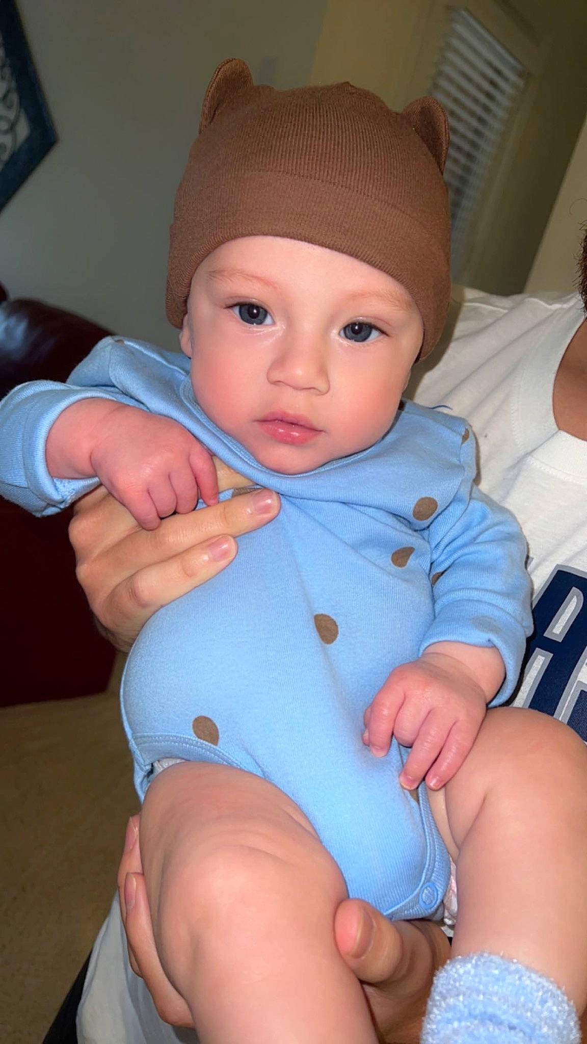 Knox is registered to the contest to win money with this photo: baby, baby_products, baby_toddler_clothing, cap, cheek, chest, child, comfort, electric_blue, finger, headgear, headwear, human_leg, knee, nail, person, sitting, skin, sleeve, thigh