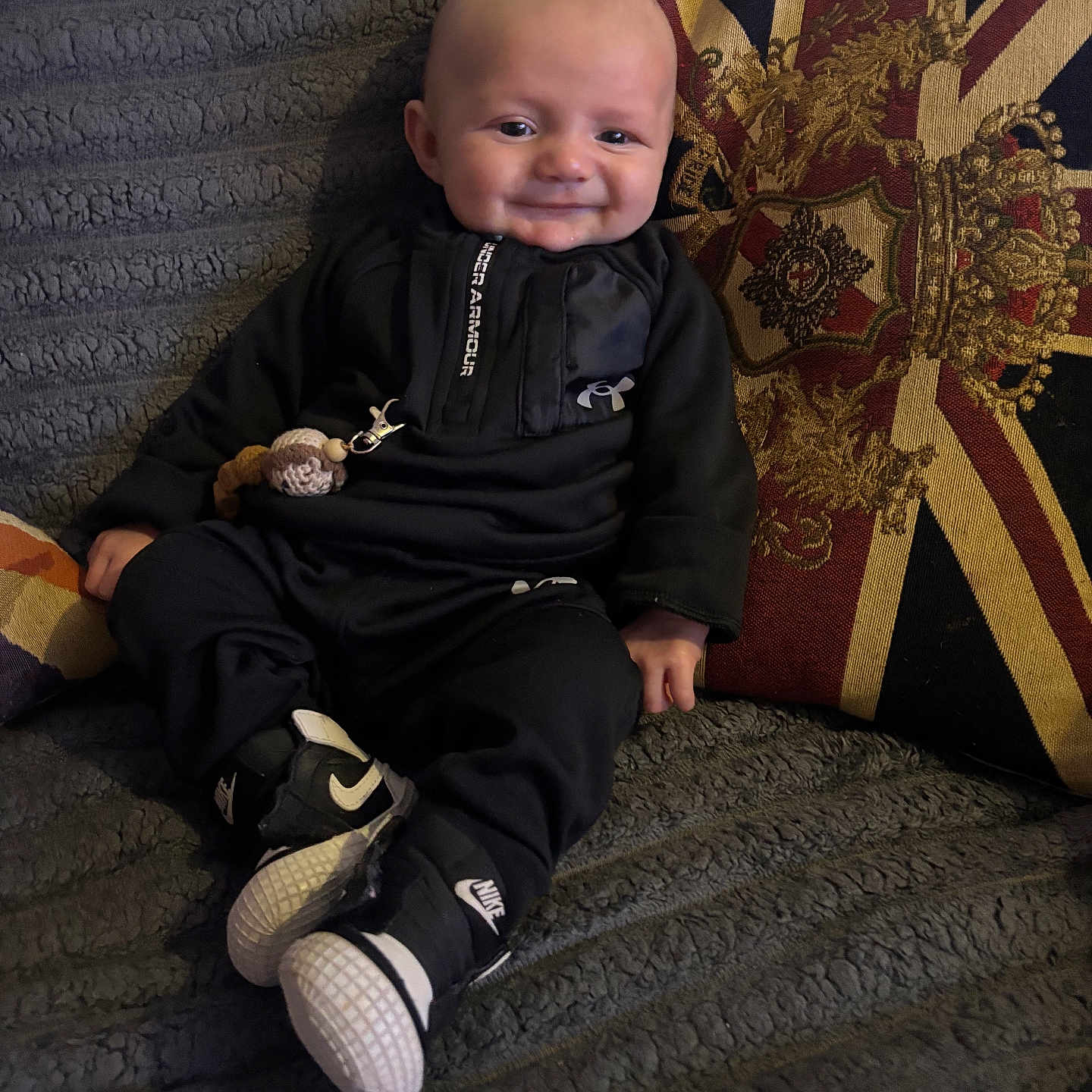 Dream joined the competition — help win amazing prizes! baby, black_clothing, blanket, child, couch, cozy, cute, fashion, happy, home, indoor, infant, nike_shoes, pillow, portrait, sitting, smiling, toy, under_armour, union_jack