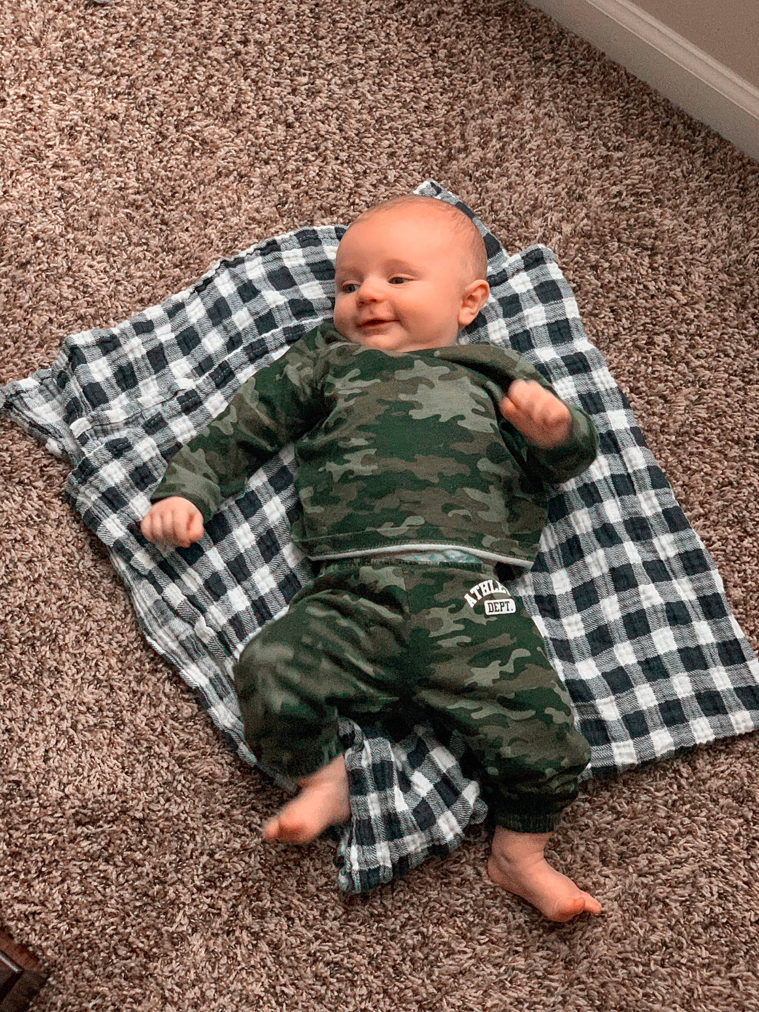 Cash is registered to the contest to win money with this photo: baby, child, design, flooring, pattern, person, plaid, sitting, tartan, textile, toddler