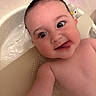 Nova is registered to the contest to win money with this photo: baby, bath, bathtub, child, closeup, cute, expression, face, head, indoors, infant, penguin, playful, selfie, skin, smile, tongue_out, toy, water, wet_hair