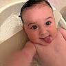 baby, bath, child, closeup, cute, expression, face, fun, happy, indoors, infant, mischievous, person, playful, portrait, skin, smiling, tongue_out, water, wet_hair
