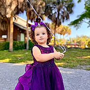 Ellary joined the competition — help win amazing prizes! background_blur, balloon_string, child, curly_hair, cute, daylight, face, girl, grass, greenery, outdoor, palm_trees, person, portrait, purple_dress, smile, string, sunny, trees, young_child