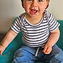 toddler, child, smiling, cap, striped_shirt, jeans, blue_shoes, sitting, indoor, happy, person, face, headwear, casual_clothing, blue, white, teal_chair, cute, young_child, portrait