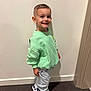 Kinsley a rejoint le concours — aidez-le/la à gagner de superbes lots ! child, boy, smile, standing, mint_green_sweatshirt, light_jeans, sneakers, indoor, carpet, wall, short_hair, happy, casual_clothing, footwear, person, portrait, young_child, full_body, fashion, cute
