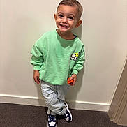 Kinsley participe au concours pour gagner de l'argent avec cette photo : child, smiling, standing, sweatshirt, jeans, sneakers, indoor, carpet, wall, person, happy, casual_clothing, short_hair, footwear, holding_object, cute, portrait, fashion, young, playful