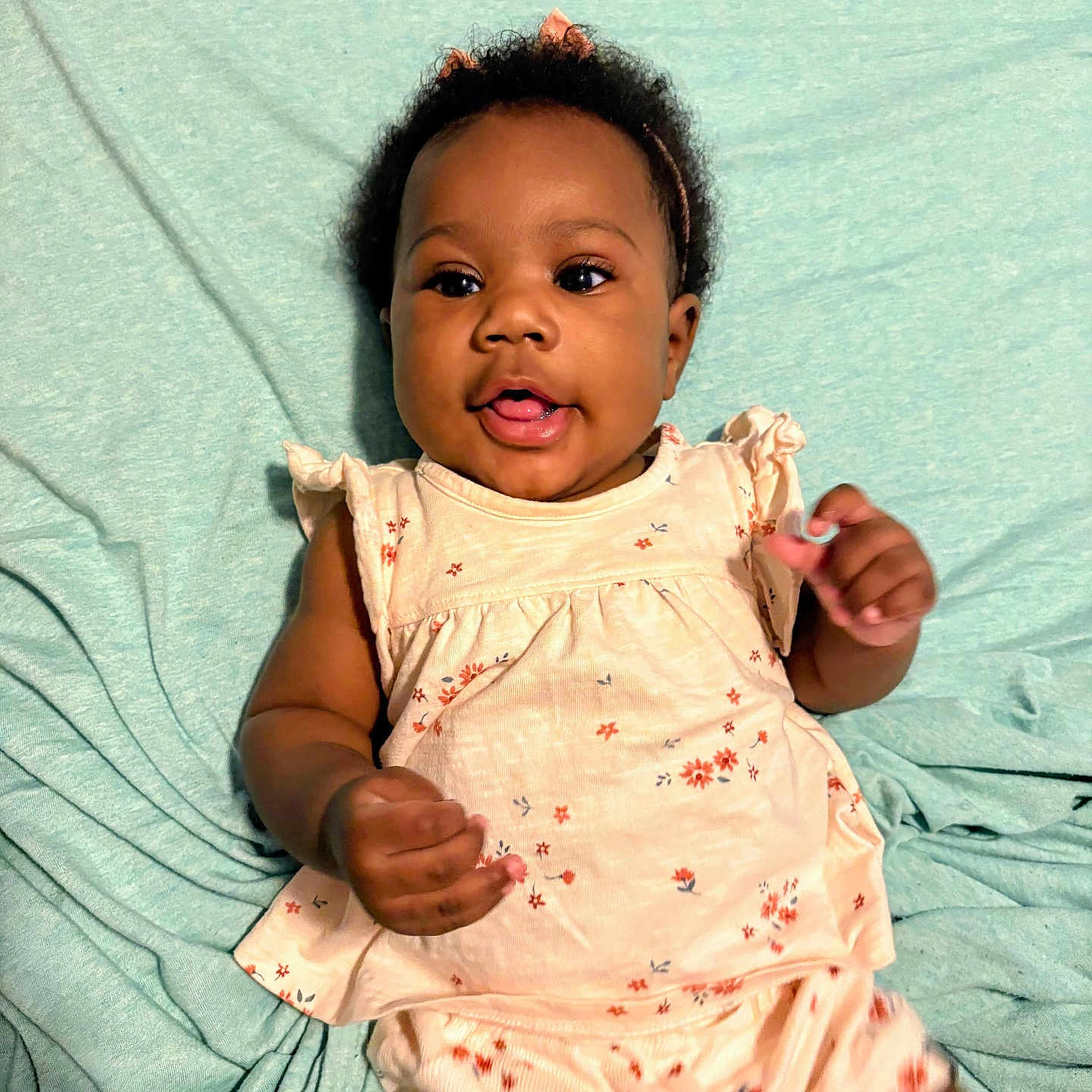 Soni joined the competition — help win amazing prizes! adorable, baby, blanket, child, cute, expression, floral_outfit, happy, headband, indoors, infant, lying_down, person, pink_bow, playful, portrait, skin, smiling, soft_texture, young_child