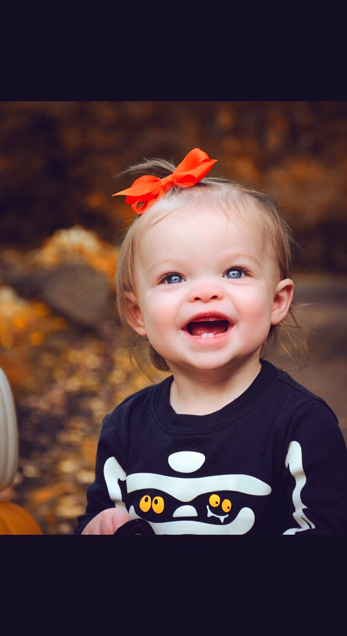 Ellie joined the competition — help win amazing prizes! baby_toddler_clothing, cheek, chin, clothing, eye, face, facial_expression, flash_photography, happy, head, iris, lip, mouth, nose, orange, organ, person, plant, sleeve, smile