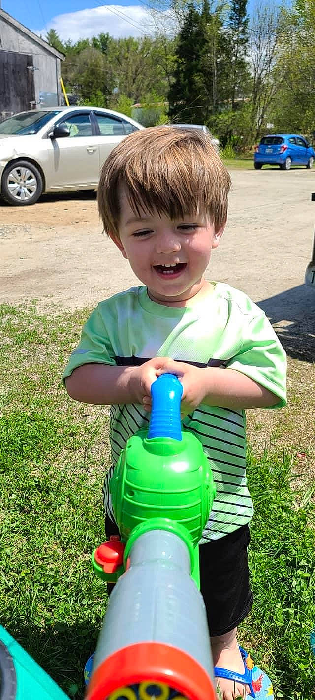 Kayson is registered to the contest to win money with this photo: blue, car, child, drink, electric_blue, fun, grass, joy, lawn, leisure, person, plant, plastic_bottle, recreation, smile, summer, t_shirt, tire, toddler, vehicle