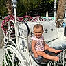 Nova joined the competition — help win amazing prizes! toddler, child, bench, white, metal, carriage, flowers, pink, outdoor, sunny, greenery, tree, smiling, portrait, seat, baby, cute, daytime, park, decorative