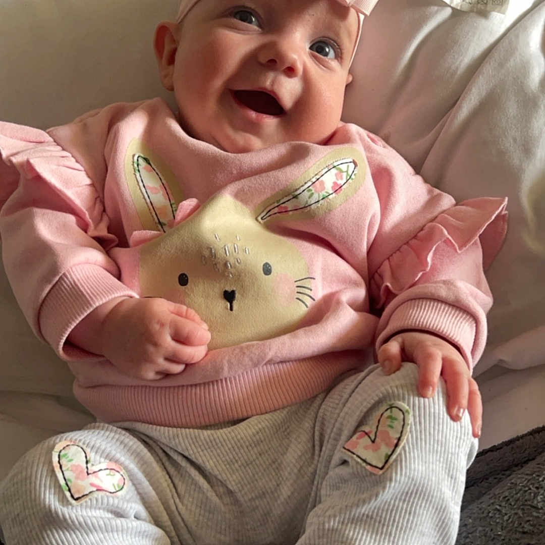 Zara-Leigh joined the competition — help win amazing prizes! baby, bodypart, clothing, costume, couch, cushion, face, finger, furniture, hand, happy, hat, head, homedecor, pants, person, photography, portrait, sitting, smile