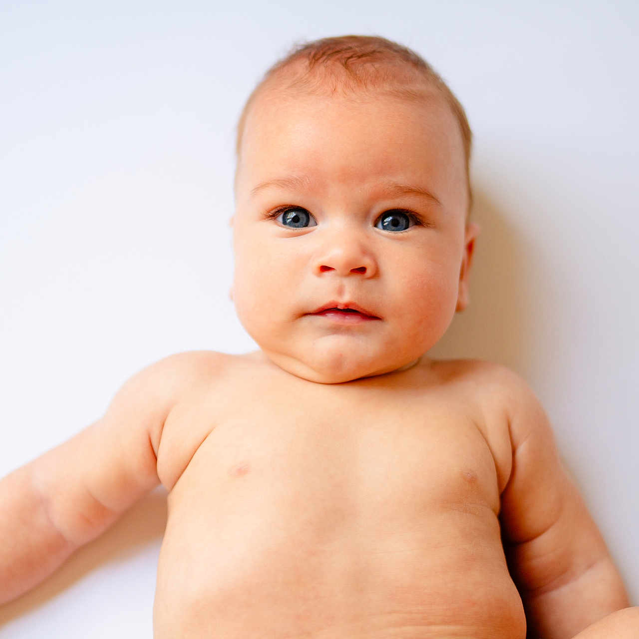 Huey joined the competition — help win amazing prizes! arms, baby, blue_eyes, body, child, chubby, closeup, cute, expression, face, head, human, infant, lying_down, naked_torso, portrait, skin, soft_lighting, white_background, young