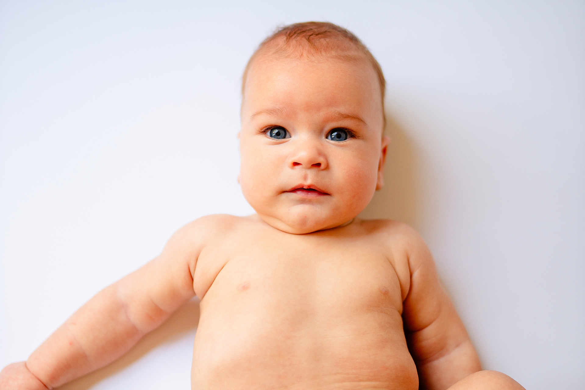Huey joined the competition — help win amazing prizes! baby, infant, child, skin, blue_eyes, chubby, cute, portrait, lying_down, naked_torso, soft_lighting, white_background, closeup, human, young, expression, face, head, arms, body