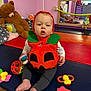 Noah participe au concours pour gagner de l'argent avec cette photo : baby, pumpkin_costume, toy, teddy_bear, mirror, playroom, child, floor_mat, colorful, indoor, cute, sitting, footwearless, reflection, stuffed_animal, pink_wall, plaything, infant, orange_costume, young_child