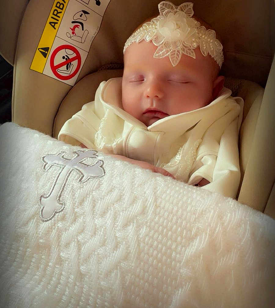 Charlize joined the competition — help win amazing prizes! baby, sleeping, infant, white_clothing, headband, flower, blanket, cross, car_seat, airbag_warning, peaceful, closeup, indoors, soft_lighting, cute, portrait, child, newborn, resting, adorable