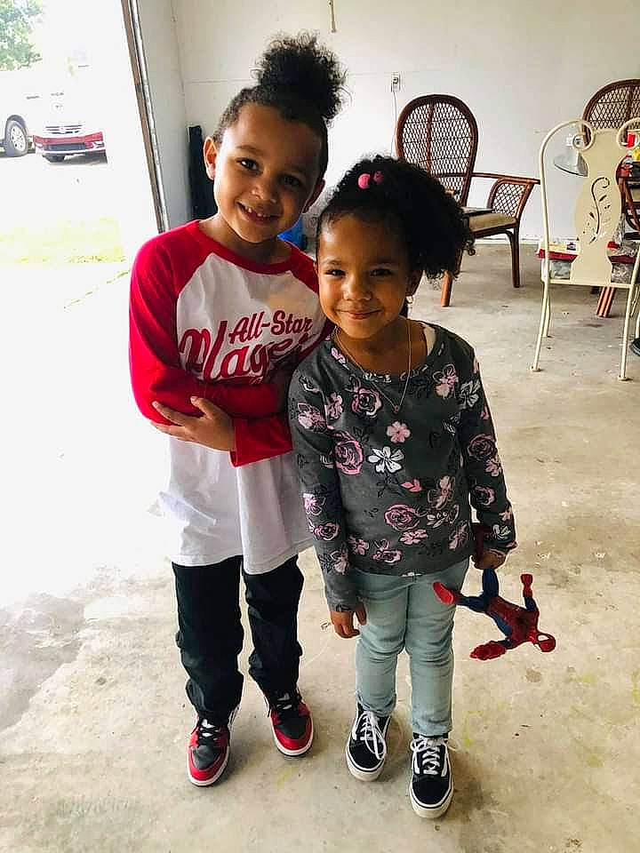 James is registered to the contest to win money with this photo: car, chair, child, event, face, flooring, friendship, fun, happy, joy, leisure, person, skin, smile, sneakers, standing, t_shirt, tire, toddler, vehicle_door