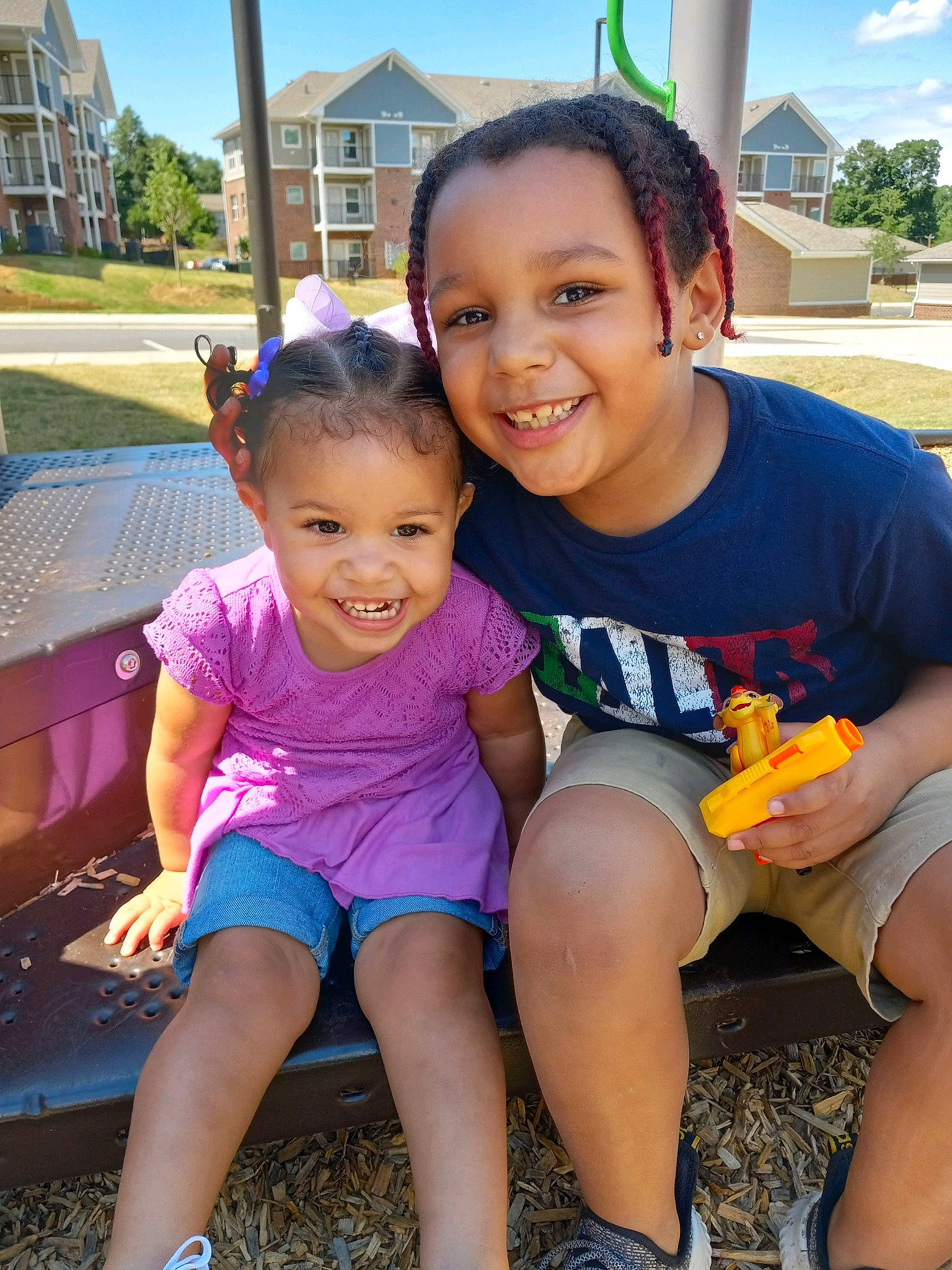 James is registered to the contest to win money with this photo: community, face, facial_expression, fun, grass, happy, joy, leaf, leg, leisure, person, plant, public_space, skin, sky, smile, summer, t_shirt, thigh, toddler