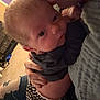 Ryder is registered to the contest to win money with this photo: baby, person, glasses, kiss, hand, clothing, indoor, carpet, checkered, pants, holding, affection, closeup, face, love, seated, casual, comfort, home, warm_lighting