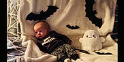 Ryder joined the competition — help win amazing prizes! baby, bat_decorations, black_and_white, blanket, child, clothing, costume, cozy, cute, decor, ghost_plush, halloween, holiday, indoors, infant, patterned_pants, plush_toy, resting, smiling_toy, soft_texture