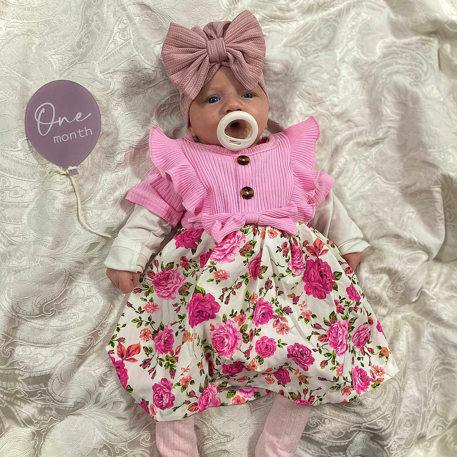 Jamila is registered to the contest to win money with this photo: baby, bonnet, clothing, costume, couch, doll, dress, face, furniture, hat, head, hosiery, person, photography, portrait, purple, sitting, sock, toy, yawning