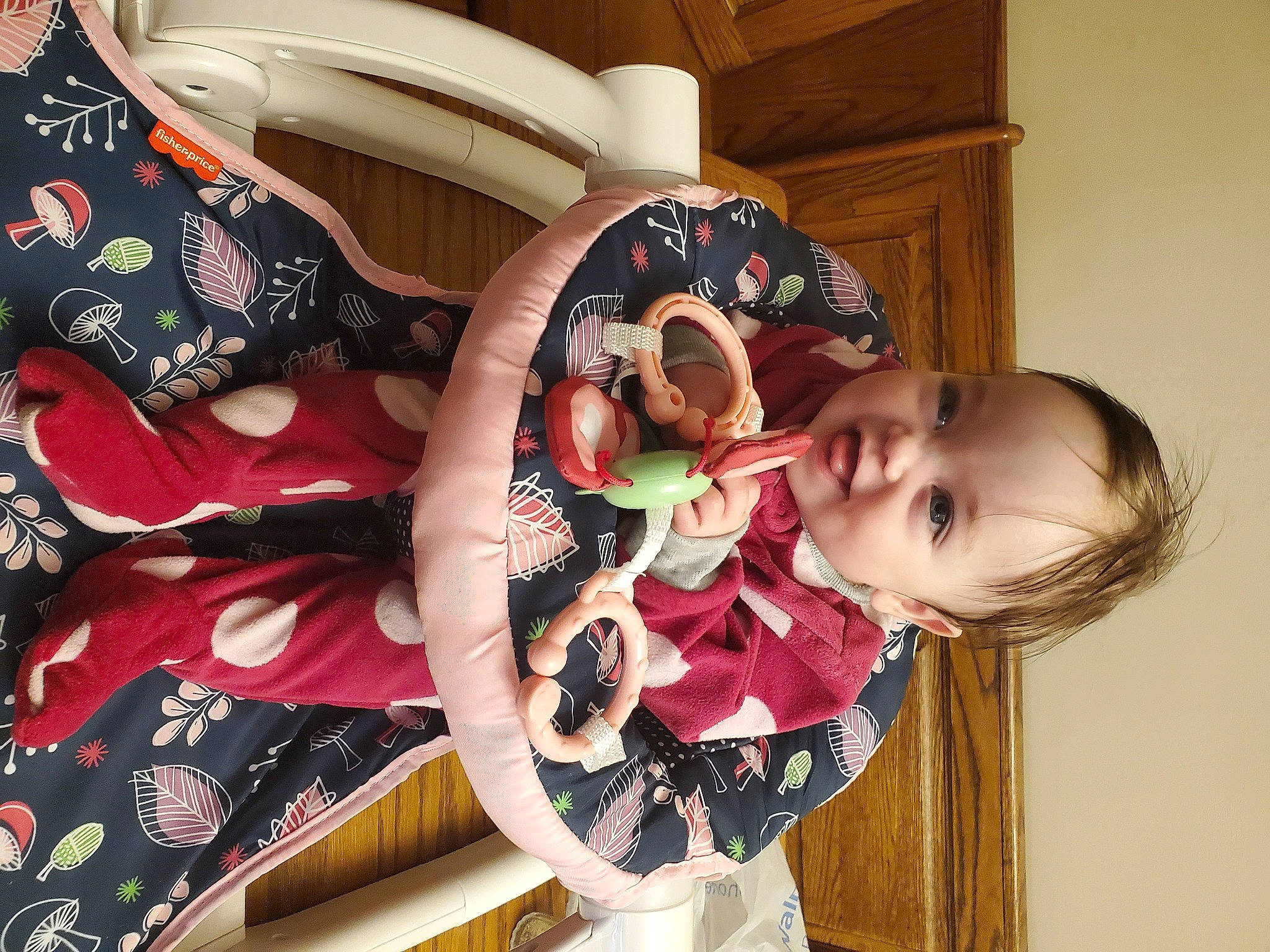 Cara is registered to the contest to win money with this photo: arm, baby, baby_toddler_clothing, carmine, child, circle, fun, happy, magenta, pattern, person, pink, room, sitting, smile, toddler, wood