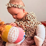 Kayla participe au concours pour gagner de l'argent avec cette photo : baby, infant, child, plush_toy, headband, leopard_print, patterned_clothing, socks, blanket, soft_texture, curious, crawling, indoors, cute, portrait, young_child, close_up, playful, colorful, cozy