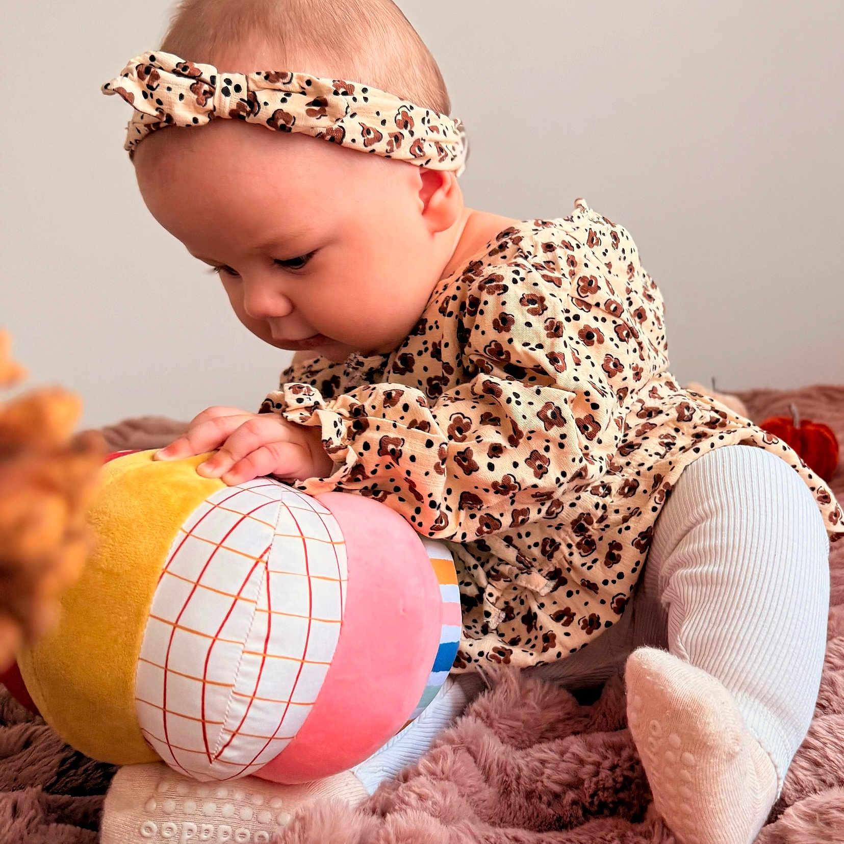 Kayla participe au concours pour gagner de l'argent avec cette photo : baby, blanket, child, close_up, colorful, cozy, crawling, curious, cute, headband, indoors, infant, leopard_print, patterned_clothing, playful, plush_toy, portrait, socks, soft_texture, young_child