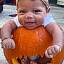 baby, pumpkin, headband, smile, outdoor, concrete, carved_pumpkin, child, cute, hands, feet, fall, halloween, happy, person, orange, playful, infant, costume, portrait