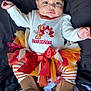 Amari is registered to the contest to win money with this photo: baby, child, thanksgiving, tutu, bow, headband, boots, striped_leggings, festive_clothing, cute, smiling, holiday, celebration, portrait, infant, outfit, colorful, lying_down, blanket, happy