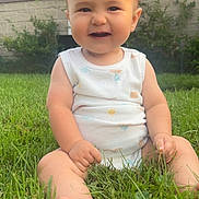 Jimmy joined the competition — help win amazing prizes! baby, child, grass, smiling, outdoor, greenery, onesie, sitting, sunlight, happy, cute, infant, person, nature, yard, summer, skin, barefoot, face, head