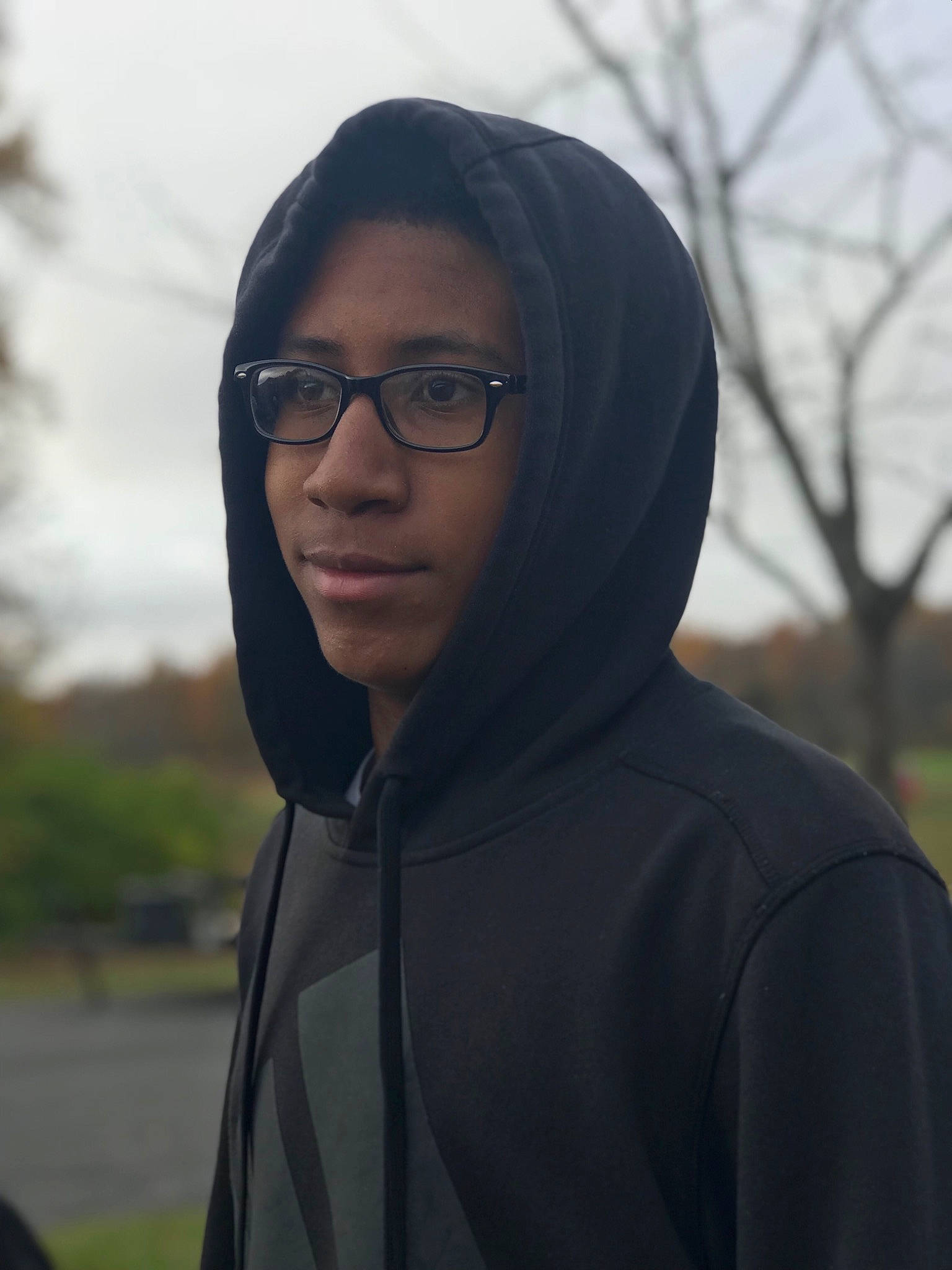 Deshawn is registered to the contest to win money with this photo: black_hair, eyewear, face, glasses, head, hoodie, jacket, lady, outerwear, person, photography, plant, smile, sunglasses, tree, vision_care