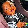 baby, car_seat, child, smiling, striped_shirt, seatbelt, toy, happy, cute, infant, portrait, indoors, child_safety, person, car_interior, face, hand, young_child, seat, bright