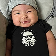 David is registered to the contest to win money with this photo: baby, baseballcap, beanie, bonnet, cap, clothing, face, happy, hat, head, hoodie, knitwear, newborn, person, photography, portrait, smile, sweater, sweatshirt, t_shirt