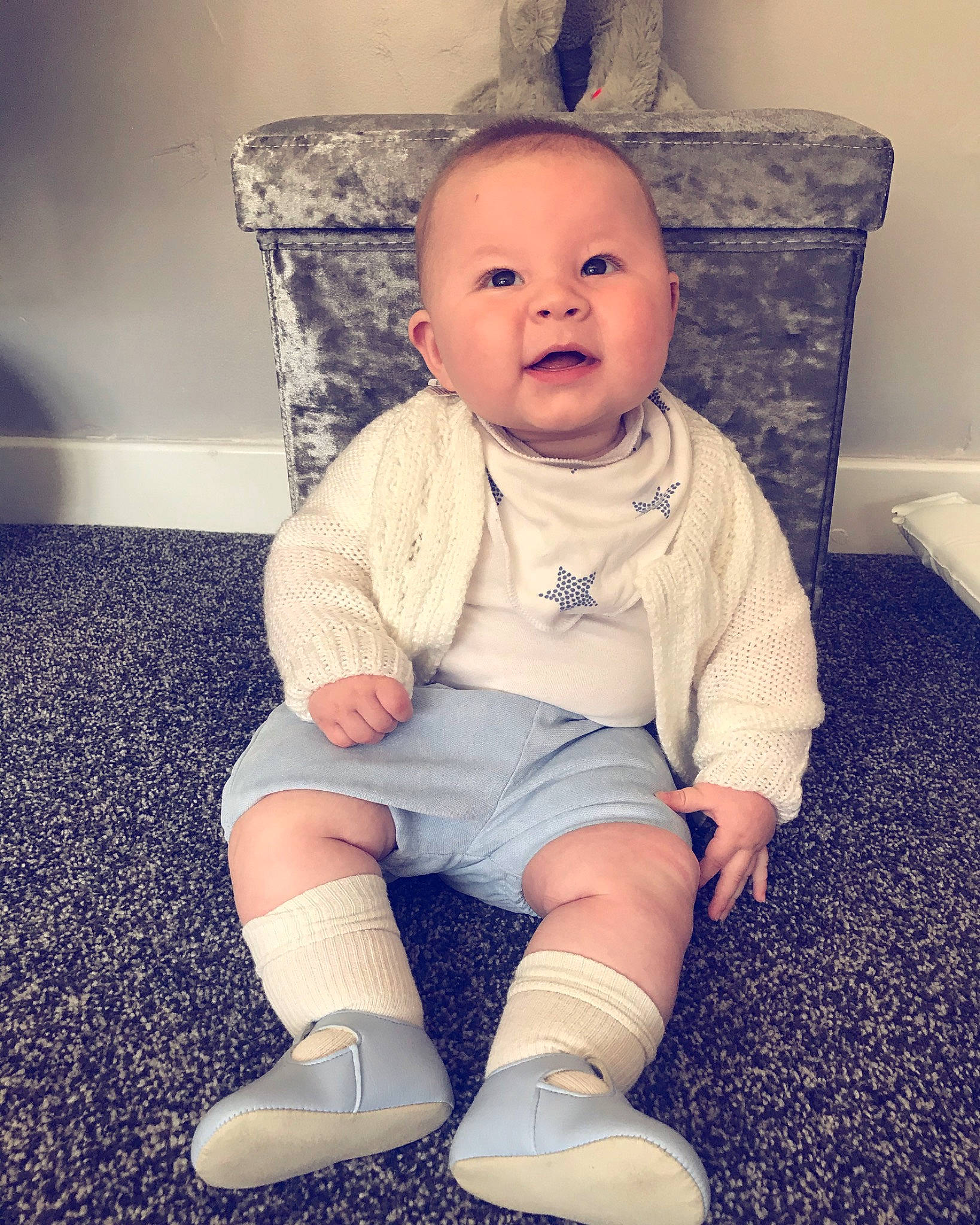 Kobi is registered to the contest to win money with this photo: arm, baby, blue, cheek, child, chin, cool, eye, face, footwear, head, knee, leg, person, shoe, sitting, skin, sleeve, smile, standing