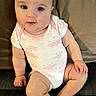 baby, infant, child, onesie, couch, seated, curious, wide_eyes, pink, white, skin, hands, legs, toes, face, expression, indoors, soft_lighting, cute, portrait