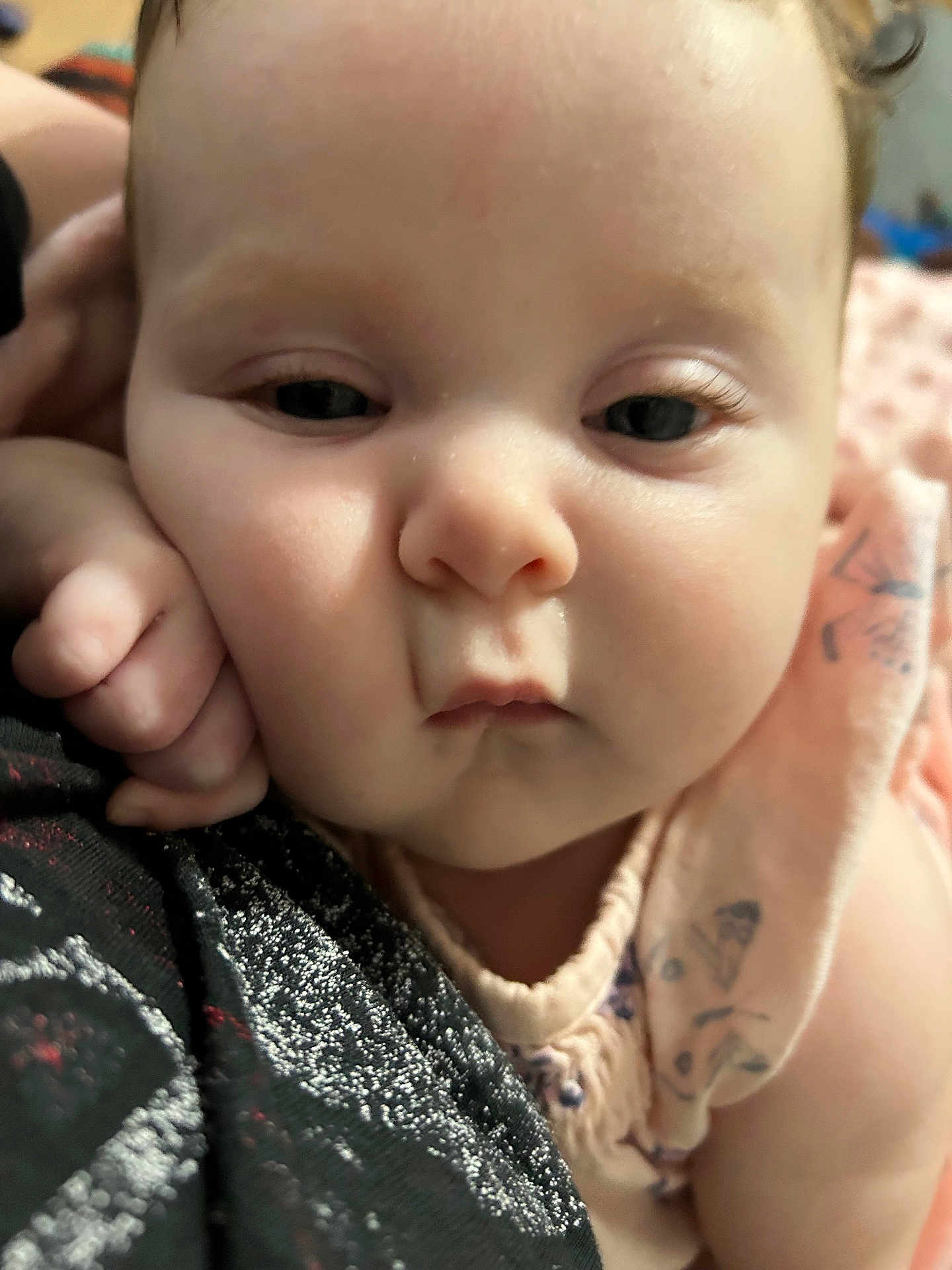 Avery is registered to the contest to win money with this photo: baby, close_up, face, cheek, hand, pink_blanket, soft_lighting, infant, cute, skin, eyelashes, resting, expression, portrait, child, young, person, indoors, warm, comfort