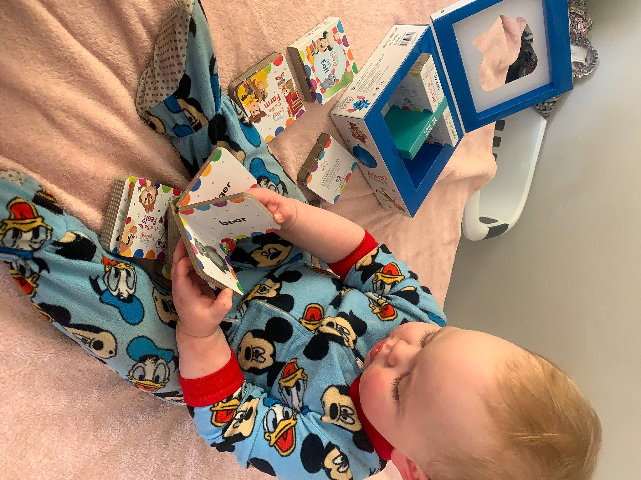 Eli is registered to the contest to win money with this photo: arm, art, artist, baby, child, elbow, eyewear, finger, hand, illustration, nail, paint, person, play, publication, room, sleeve, t_shirt, toddler, visual_arts