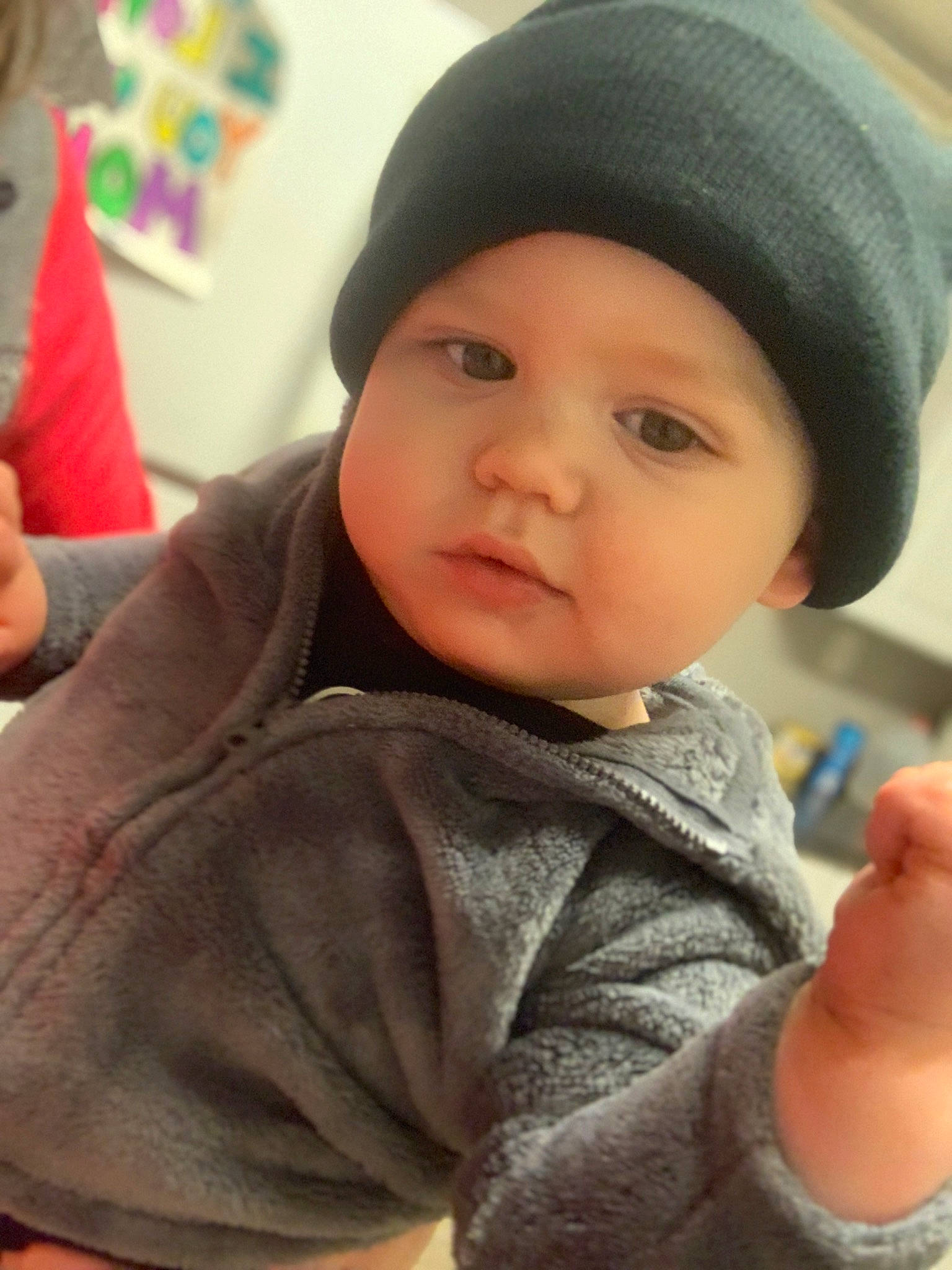 Eli is registered to the contest to win money with this photo: baby, baby_toddler_clothing, cap, cheek, child, chin, eye, eyebrow, finger, forehead, gesture, happy, headwear, knit_cap, lip, mouth, nose, person, skin, sleeve