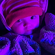 Chippy is registered to the contest to win money with this photo: baby, child, blanket, beanie, hat, striped, face, person, portrait, closeup, indoor, warm, cozy, soft, purple_light, blue_light, cute, infant, wrapped, sleepy