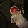 Chippy joined the competition — help win amazing prizes! baby, child, hoodie, red_hat, remote_control, couch, pillow, indoor, cute, smile, person, infant, clothing, blanket, relaxed, home, cozy, portrait, sitting, furniture