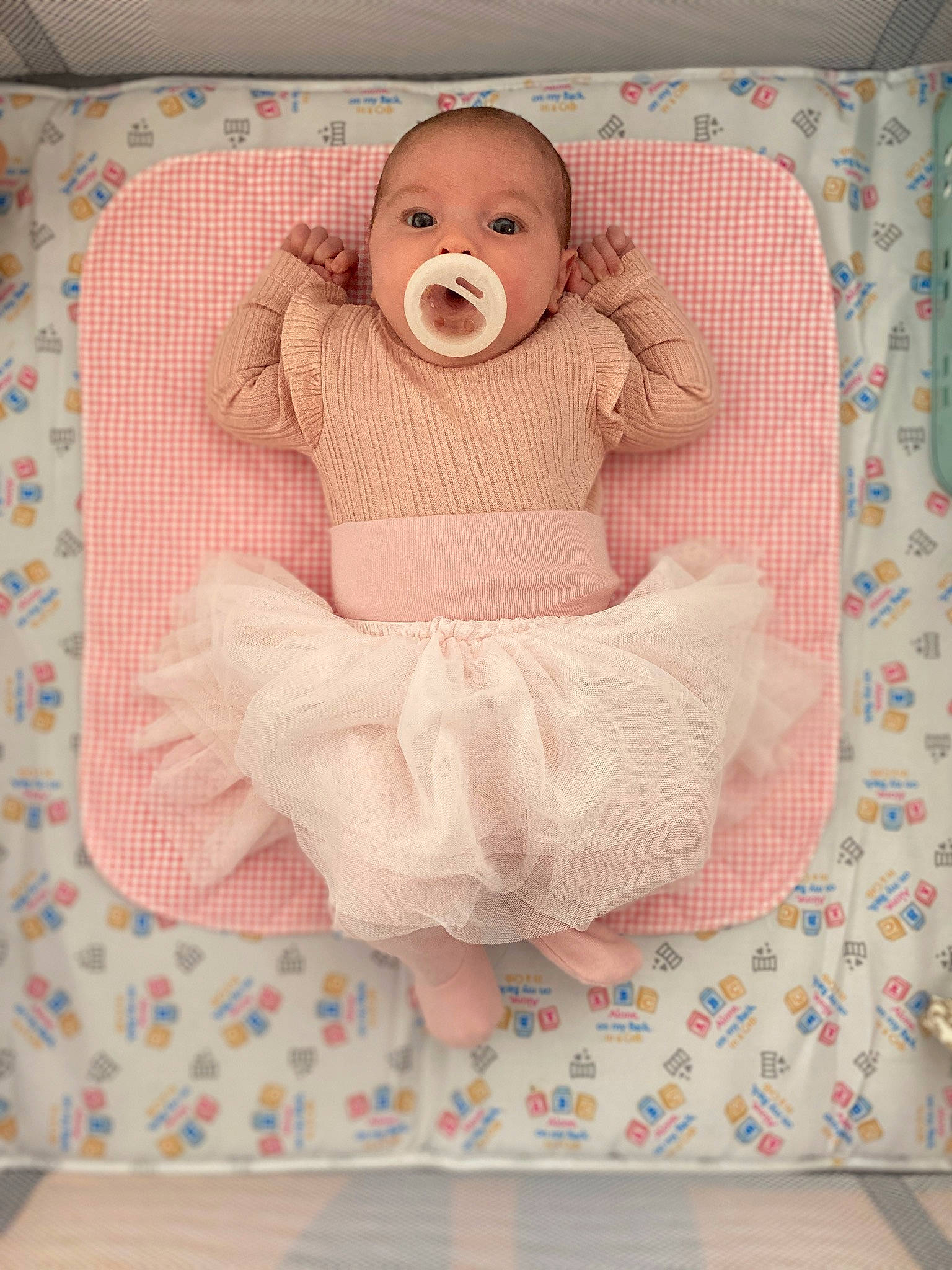 Aria is registered to the contest to win money with this photo: baby, baby_products, baby_safety, baby_sleeping, baby_toddler_clothing, baby_toys, bedding, child, comfort, cradle, infant_bed, linens, pattern, person, pink, room, sitting, sleeve, smile, textile