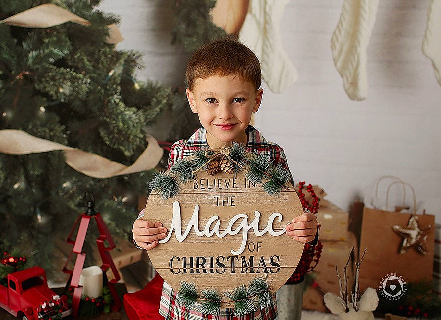 Loki is registered to the contest to win money with this photo: child, christmas, christmas_decoration, christmas_eve, christmas_ornament, christmas_tree, event, formal_wear, happy, holiday, holiday_ornament, joy, ornament, person, sitting, sleeve, smile, tie, toddler, tradition