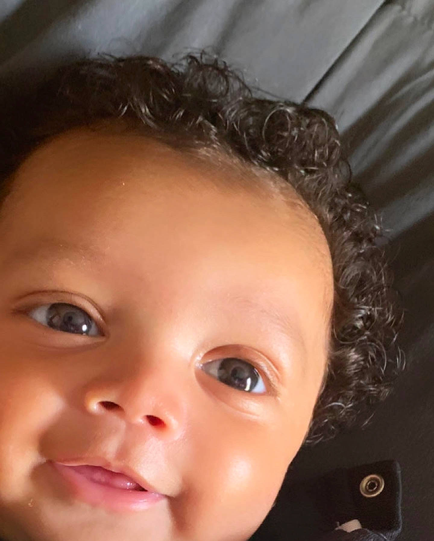 Peter is registered to the contest to win money with this photo: baby, black_hair, cheek, chin, ear, eye, eyebrow, eyelash, flash_photography, forehead, happy, head, iris, jaw, lip, mouth, neck, nose, person, skin