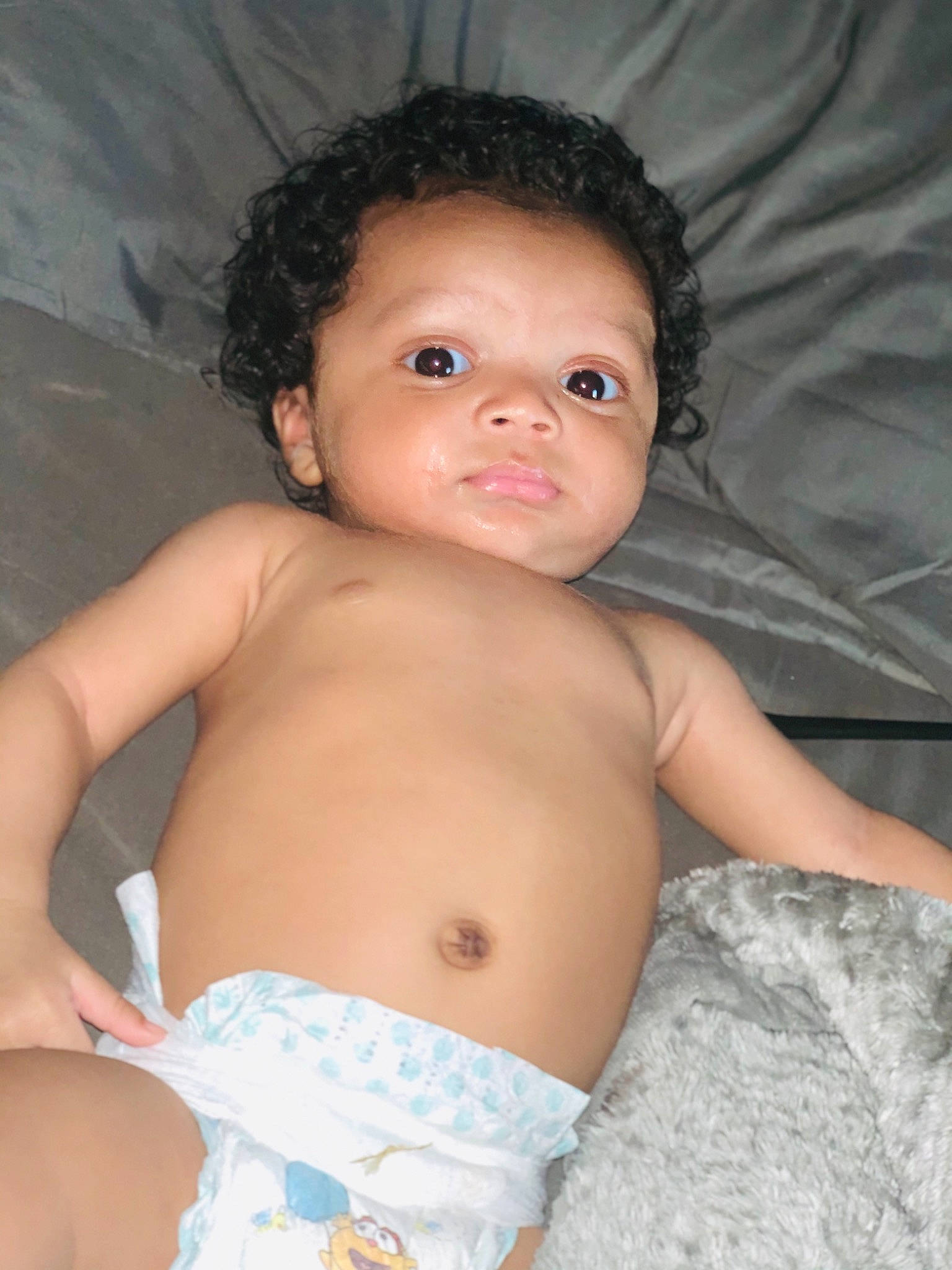 Peter is registered to the contest to win money with this photo: baby, black_hair, cheek, chest, eye, eyebrow, eyelash, finger, flash_photography, hair, head, human_body, iris, lip, mouth, neck, nose, person, shoulder, skin