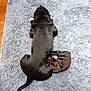 dog, puppy, black_dog, brindle_puppy, cuddling, lying_down, fluffy_rug, gray_rug, wood_floor, indoor, pet, sleeping, resting, companion, animal, cute, cozy, domestic, fur, tail