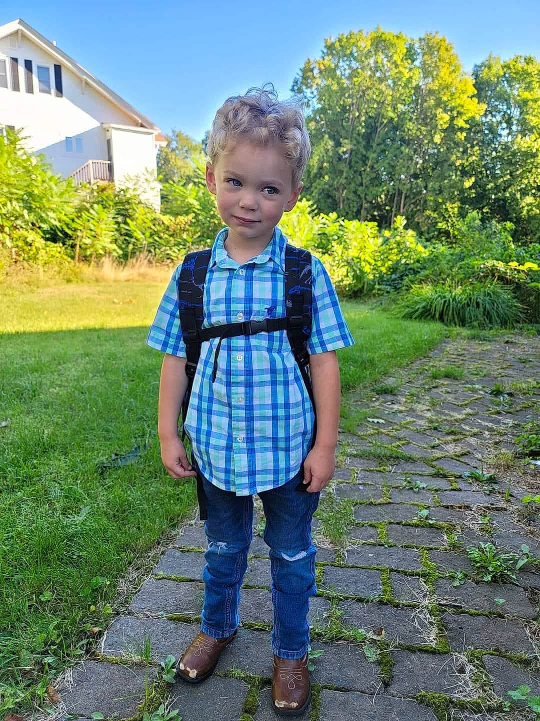 Leonardo is registered to the contest to win money with this photo: baby_toddler_clothing, denim, electric_blue, grass, grass_family, grassland, head, jeans, joy, landscape, leaf, leisure, pattern, people_in_nature, person, plaid, plant, sky, summer, toddler