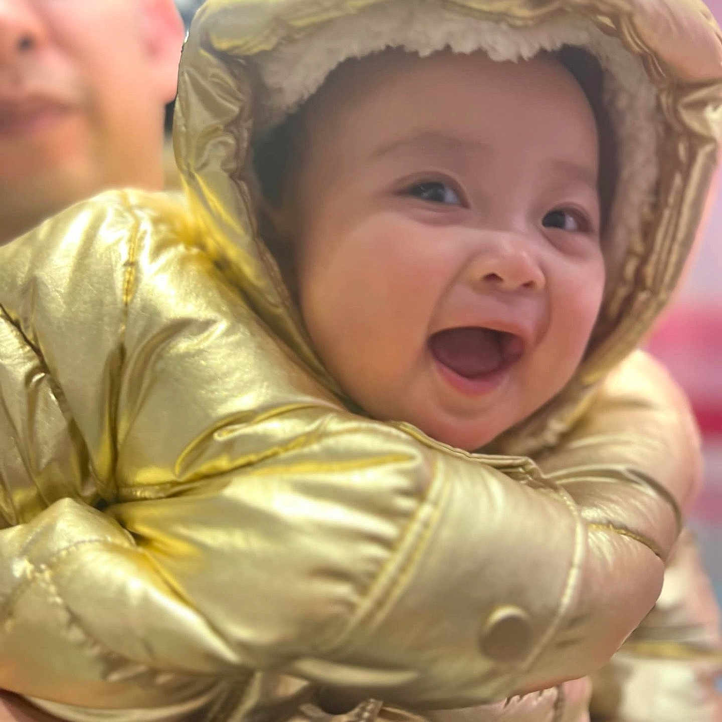 Daphne is registered to the contest to win money with this photo: baby, babylaughing, bonnet, clothing, coat, costume, face, happy, hat, head, hood, jacket, person, photography, portrait