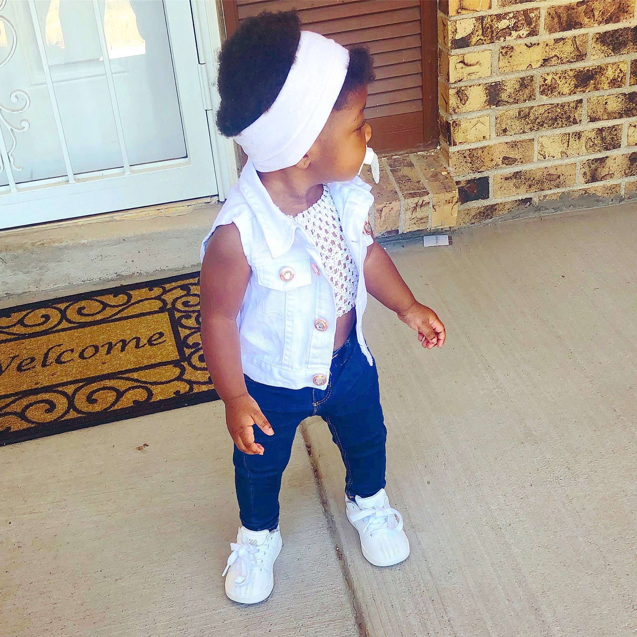 Miyah is registered to the contest to win money with this photo: baby, beanie, cap, child, clothing, cool, fashion, fashion_accessory, footwear, headgear, jeans, outerwear, person, shoe, sleeve, t_shirt, toddler, trousers, white